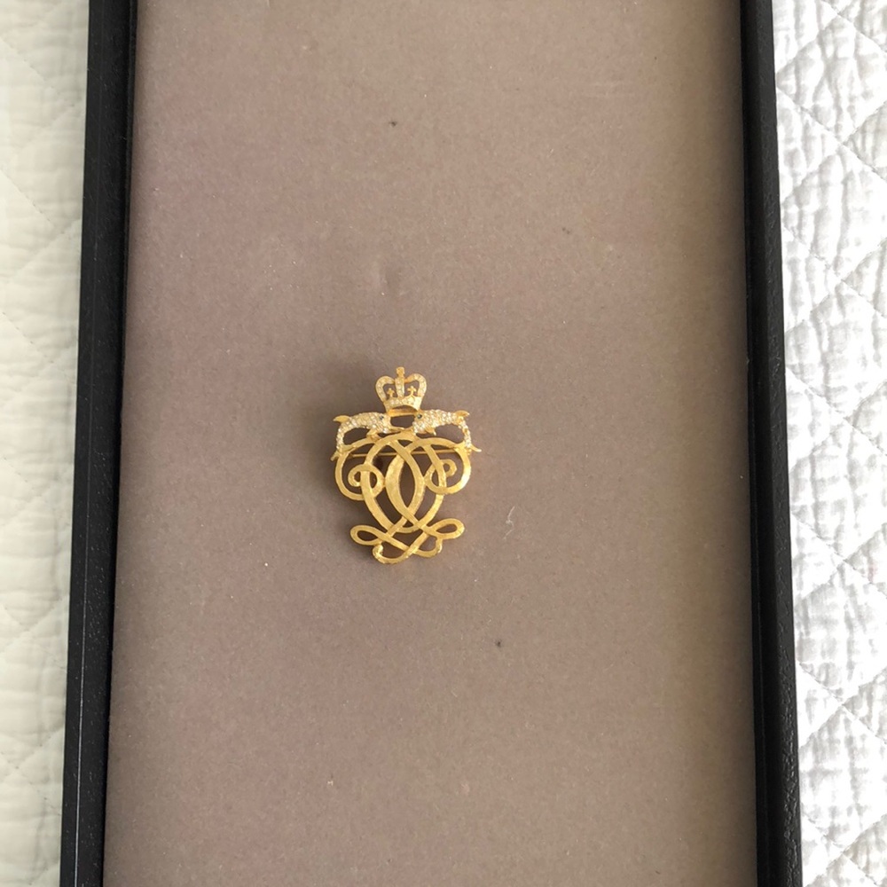 Gold brooch with dolphins and faux stones
